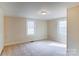 Well-lit bedroom with carpeting and ample closet space at 94 Sumner Nw Ave, Concord, NC 28027