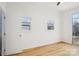 Open bedroom with natural light, hardwood floors, and 2 windows at 971 Westmere Ave, Charlotte, NC 28208
