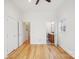 Bright bedroom with light hardwood floors, white walls, closet, and bathroom doorways at 971 Westmere Ave, Charlotte, NC 28208