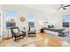 Sun-filled main bedroom with sitting area, ceiling fan, and large windows at 971 Westmere Ave, Charlotte, NC 28208