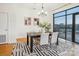 Dining area with modern table, chairs, and a large window that provides natural light at 971 Westmere Ave, Charlotte, NC 28208