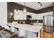 Kitchen with modern stainless steel appliances, subway tile backsplash, quartz countertops, and bar seating at 971 Westmere Ave, Charlotte, NC 28208