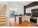 Modern kitchen with white cabinets, stainless steel appliances, and stylish black subway tile backsplash at 971 Westmere Ave, Charlotte, NC 28208