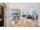 Open-concept living room with dining area, hardwood floors, and large windows for natural light at 971 Westmere Ave, Charlotte, NC 28208