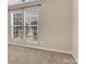 Bedroom showcasing natural light from two windows, complemented by neutral walls and plush carpeting at 1027 Fountainbrook Dr, Indian Trail, NC 28079