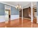 Formal dining room with a view of the stairway and eat-in kitchen, featuring wood flooring at 1027 Fountainbrook Dr, Indian Trail, NC 28079