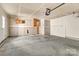 A spacious unfinished garage with concrete floor, side door, and ample storage space at 1027 Fountainbrook Dr, Indian Trail, NC 28079