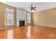 Living room featuring a fireplace, ceiling fan, and plenty of natural light at 1027 Fountainbrook Dr, Indian Trail, NC 28079