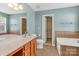 Main bathroom featuring a double sink vanity, tile flooring, separate shower, and garden tub at 1027 Fountainbrook Dr, Indian Trail, NC 28079