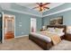 Spacious main bedroom featuring a tray ceiling, ceiling fan, and ensuite bathroom at 1027 Fountainbrook Dr, Indian Trail, NC 28079