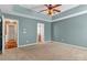 Spacious main bedroom featuring carpet, a tray ceiling, ceiling fan, and ensuite bathroom at 1027 Fountainbrook Dr, Indian Trail, NC 28079