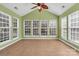 Bright sunroom with tile floors, large windows, and a vaulted ceiling with ceiling fan at 1027 Fountainbrook Dr, Indian Trail, NC 28079