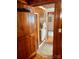 Hall bathroom with wood paneling, tile flooring, and a linen closet at 110 30Th Nw Ave, Hickory, NC 28601