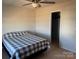 Bedroom with ceiling fan, closet, and gray and white bedding at 1112 Culver Spring Way, Charlotte, NC 28215