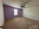 Spacious bedroom with purple accent wall and ceiling fan at 1112 Culver Spring Way, Charlotte, NC 28215