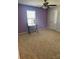 Bedroom with purple accent wall, ceiling fan, and small workspace at 1112 Culver Spring Way, Charlotte, NC 28215