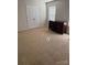 Bedroom with neutral carpeting, dresser, and double doors to closet at 1112 Culver Spring Way, Charlotte, NC 28215