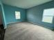 Bedroom with teal and gray walls, and neutral carpeting at 1112 Culver Spring Way, Charlotte, NC 28215