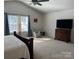 Main bedroom with large windows, seating area, and TV at 1112 Culver Spring Way, Charlotte, NC 28215