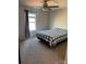 Bedroom with ceiling fan, window, and gray and white bedding at 1112 Culver Spring Way, Charlotte, NC 28215