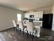 Modern kitchen with white cabinets, granite island, and stainless steel appliances at 1112 Culver Spring Way, Charlotte, NC 28215