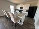 Open kitchen boasts granite island, white cabinets, and stainless steel appliances at 1112 Culver Spring Way, Charlotte, NC 28215