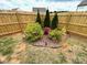 Landscaped backyard area with bushes and trees at 1112 Culver Spring Way, Charlotte, NC 28215