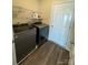 Laundry room with washer, dryer, and ample shelving at 1112 Culver Spring Way, Charlotte, NC 28215