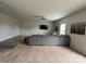 Spacious living room with gray sectional sofa and carpet at 1112 Culver Spring Way, Charlotte, NC 28215