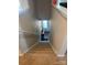 Carpeted staircase leading to the entryway with a visible window at 1112 Culver Spring Way, Charlotte, NC 28215