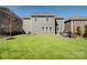 Large, level backyard featuring green grass, a patio with outdoor seating, and privacy fence at 11317 Trailside Nw Rd, Huntersville, NC 28078