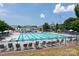 Community pool with lap lanes and lounge chairs under a blue sky, great for recreation at 11317 Trailside Nw Rd, Huntersville, NC 28078