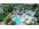 Aerial view of community pool with multiple pools, playground, tennis courts and clubhouse at 11317 Trailside Nw Rd, Huntersville, NC 28078