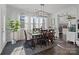 Elegant dining room features a large table, six chairs, and a modern chandelier at 11317 Trailside Nw Rd, Huntersville, NC 28078