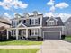 Gray two-story house with a two-car garage and landscaped lawn at 11317 Trailside Nw Rd, Huntersville, NC 28078