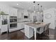 Bright kitchen boasts granite countertops, stainless steel appliances, and white shaker cabinets at 11317 Trailside Nw Rd, Huntersville, NC 28078