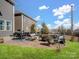 Outdoor patio with fire pit, seating area and string lights, great for entertaining guests at 11317 Trailside Nw Rd, Huntersville, NC 28078