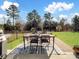Outdoor patio space with dining table and chairs on brick pavers, overlooks backyard at 11317 Trailside Nw Rd, Huntersville, NC 28078