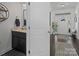 Powder room with dark vanity, marble countertop, and stylish fixtures at 11317 Trailside Nw Rd, Huntersville, NC 28078