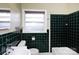 Bathroom with dark green tile and a shower/tub combo at 1138 Norland Rd, Charlotte, NC 28205