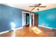 Bright bedroom with hardwood floors and teal walls at 1138 Norland Rd, Charlotte, NC 28205