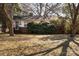 Brick ranch house with mature trees and a well-maintained lawn at 1138 Norland Rd, Charlotte, NC 28205