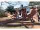 Brick home side view with a small patio and landscaping at 1138 Norland Rd, Charlotte, NC 28205