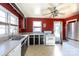 Galley kitchen with red walls, black cabinets, and appliances at 1138 Norland Rd, Charlotte, NC 28205