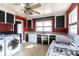 Kitchen with red walls and black cabinets, appliances included at 1138 Norland Rd, Charlotte, NC 28205