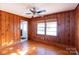 Cozy living room featuring wood walls and hardwood floors at 1138 Norland Rd, Charlotte, NC 28205