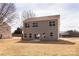 Back view of a two-story home with a level, grassy backyard, offering potential for outdoor enjoyment and landscaping at 116 Durham Rd, Stanley, NC 28164