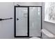 This bathroom features a black-framed shower, neutral tile, and black hardware in a modern design at 116 Durham Rd, Stanley, NC 28164