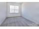 This bedroom features a window for natural light and neutral carpet flooring for comfort at 116 Durham Rd, Stanley, NC 28164