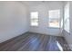 This bedroom features wood-look flooring, natural light from two windows and neutral color palette at 116 Durham Rd, Stanley, NC 28164